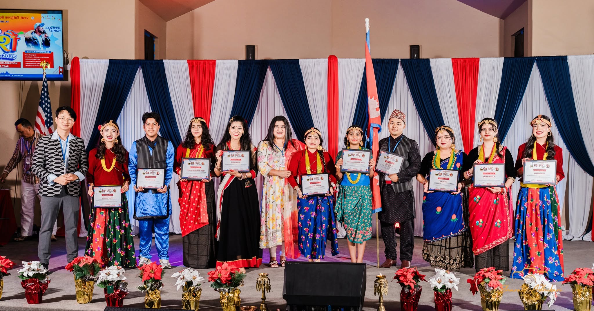 Volunteers and performers receiving appreciation certificates on stage
