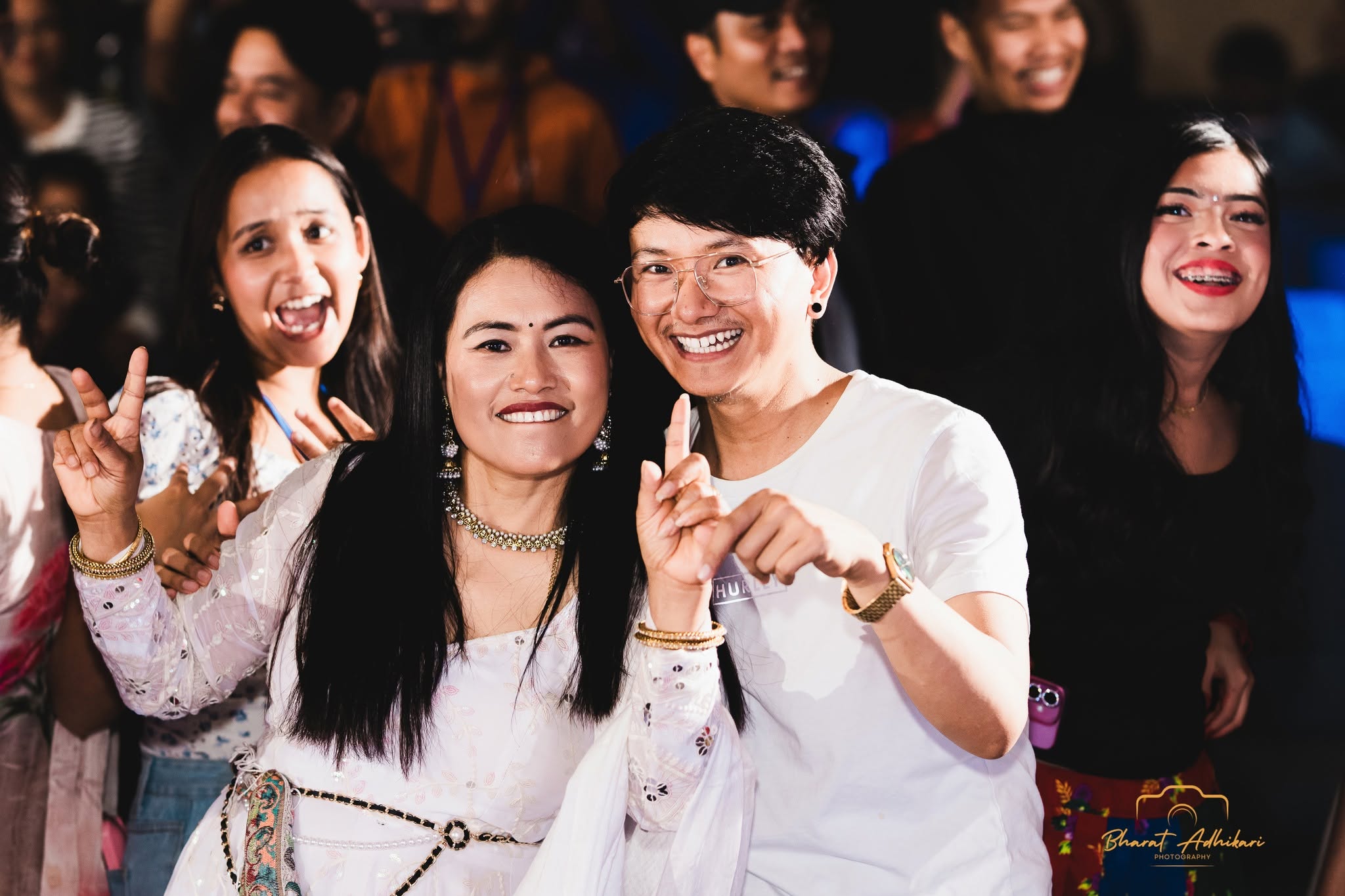 Friends posing together and smiling at the Mela